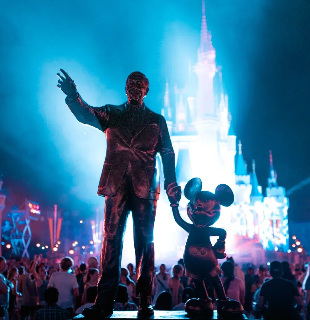 Man and Mickey Mouse statue in Disney Castle: Walk Disney and Mickey Mouse